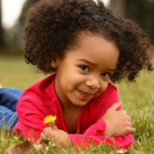 African American little girl  lying on the grass